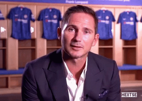 Man in Suit in Front of Blue Shirts