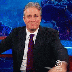 Man In Suit In Front Of Comedy Studios GIF