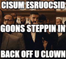 Man in Suit in Front of Crowd Saying Goons Steppin
