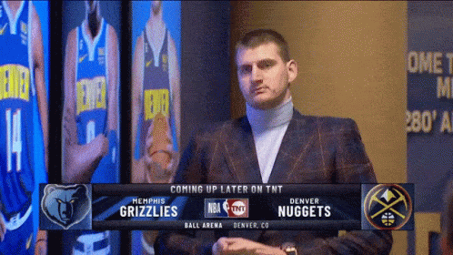 Man In Suit In Front Of Denver Nuggets Screen GIF