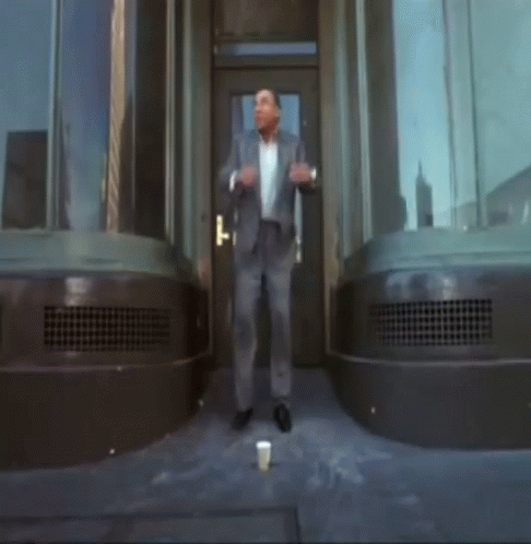 Man In Suit In Front Of Door GIF