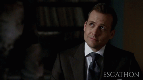 Man In Suit In Front Of Escalhon Sign GIF