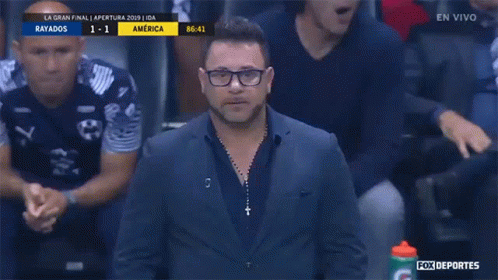 Man In Suit In Front Of Fox Deportes Advertisement GIF
