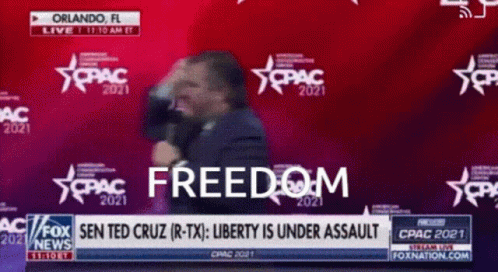 Man in Suit in Front of Freedom Screen