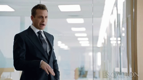 Man In Suit In Front Of Glass Wall Saying Escathion GIF