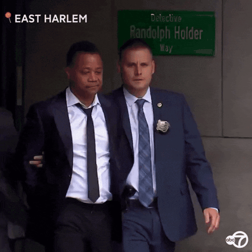 Man In Suit In Front Of Police Lineup 0 To 60 GIF
