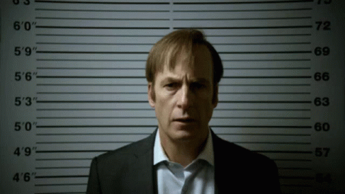 Man In Suit In Front Of Police Lineup Numbers 0 To 60 GIF