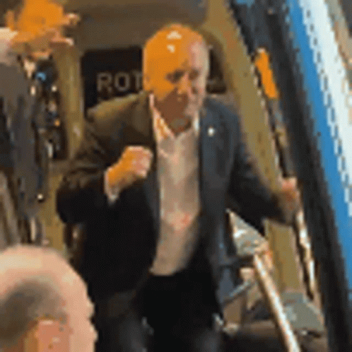 Man In Suit In Front Of Rot Sign GIF