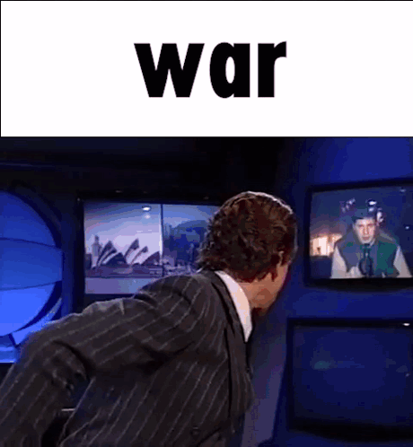 Man in Suit in Front of TV Saying War