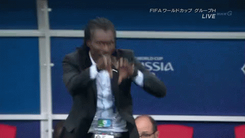 Man in Suit in Front of Wall Saying Russia