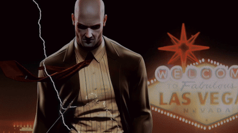 Man in Suit in Front of Welcome to Las Vegas Sign
