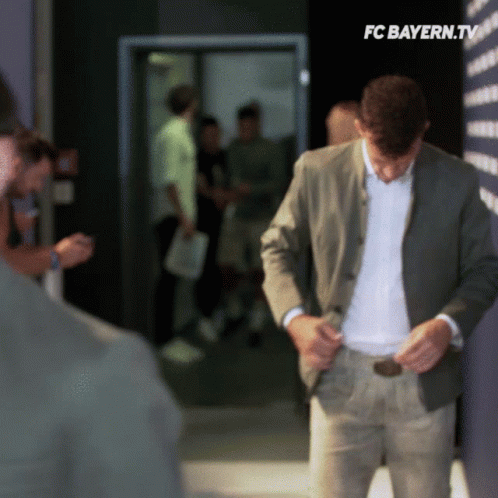 Man in Suit in Hallway with FC Bayern.tv