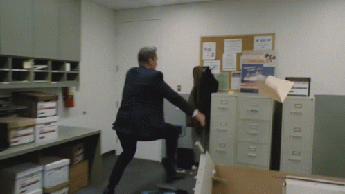 Man In Suit Kicking Chair With Mickey Mouse Picture GIF