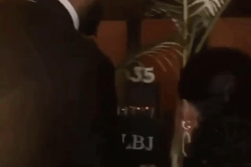 Man in Suit Kissing Woman