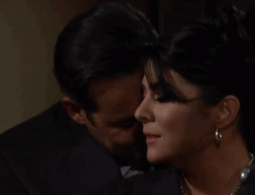 Man in Suit Kissing Woman