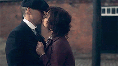 Man In Suit Kissing Woman On Cheek GIF