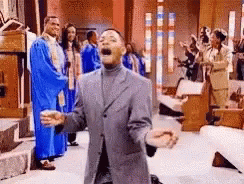 Man In Suit Kneeling Before Church Choir GIF