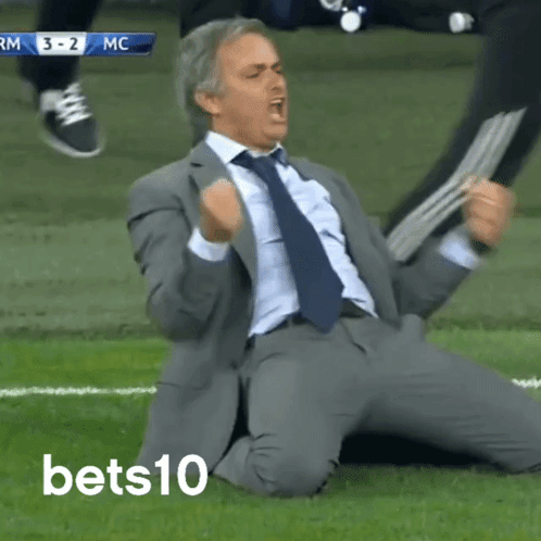 Man in Suit Kneeling on Field
