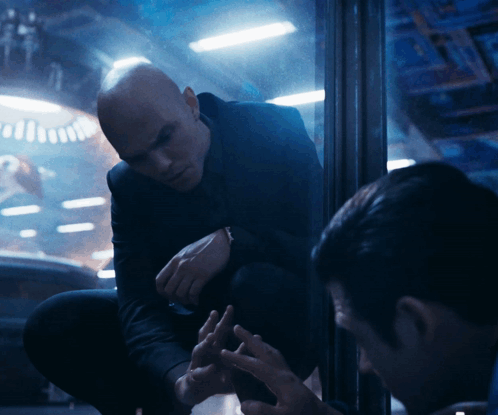 Man in Suit Kneeling Talking to Man