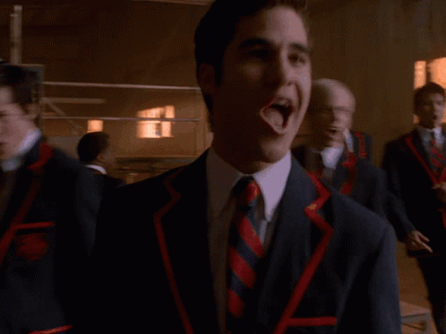 Man in Suit Laughing Beside Two Men
