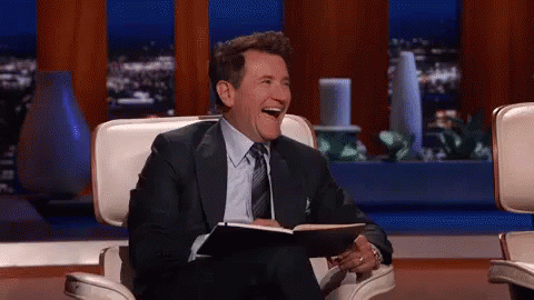 Man In Suit Laughing Holding Notebook GIF