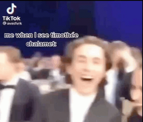Man in Suit Laughing in Crowd