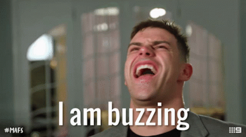 Man In Suit Laughing With Text I Am Buzzing GIF