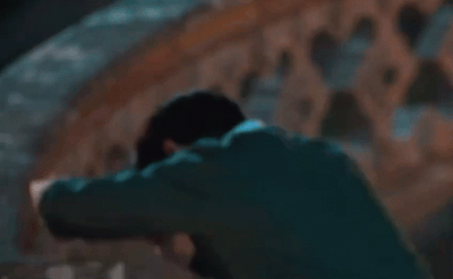Man In Suit Laying Head On Railing GIF