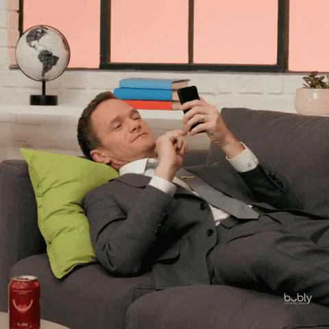 Man in Suit Laying on Couch With Bubbly