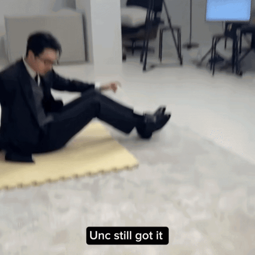 Man in Suit Laying on Floor Unc Still Got It