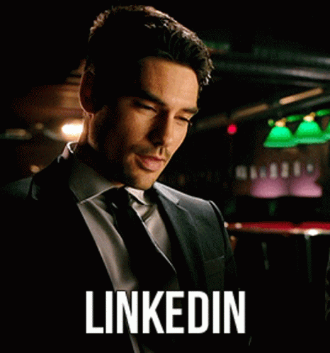 Man in Suit Looking at Phone LinkedIn