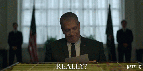 Man in Suit Looking at Really Paper