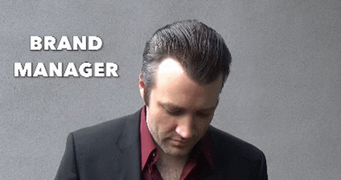 Man in Suit Looking Down Brand Manager