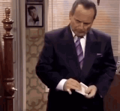 Man in Suit Looking Into Pockets