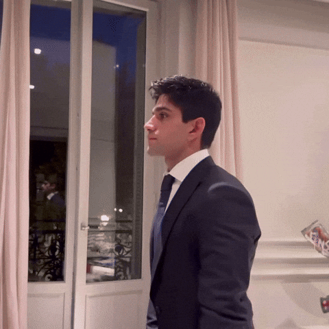 Man in Suit Looking Out Window