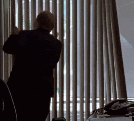 Man in Suit Looking Out Window