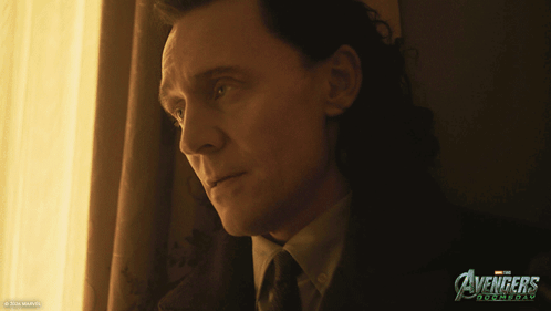Man In Suit Looking Out Window With Avengers Roomday Poster GIF