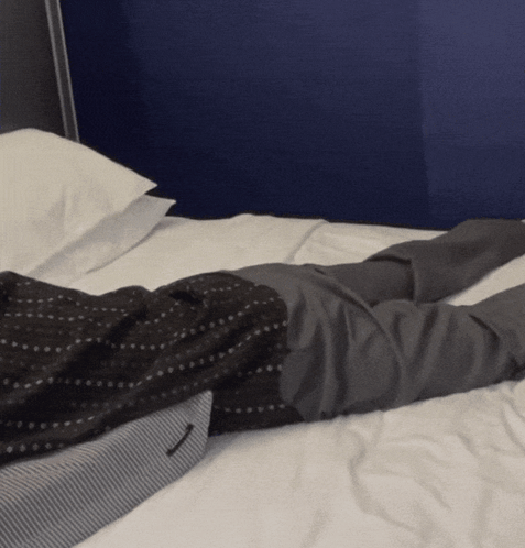 Man in Suit Lying on Bed Crossed Legs