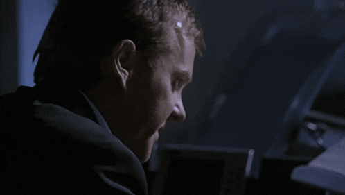Man in Suit Making Face in Dark
