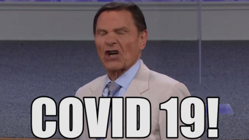 Man in Suit Making Face Says Covid 19