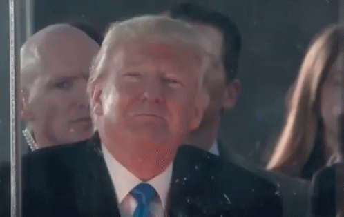 Man in Suit Making Funny Face in Front of Crowd