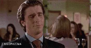 Man in Suit Making Funny Face in Front of Crowd