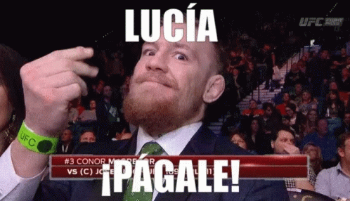 Man in Suit Making Funny Face in Front of Lucia Pagale Sign
