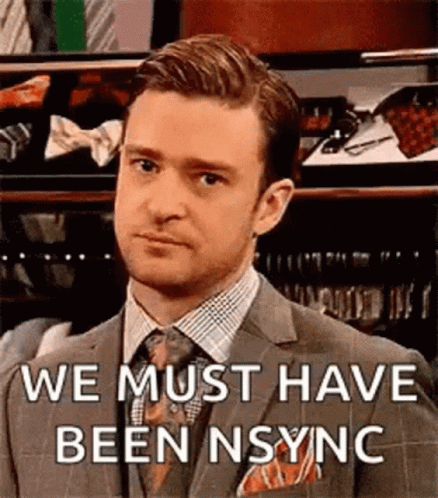 Man In Suit Making Funny Face Says We Must Have Been Sync GIF
