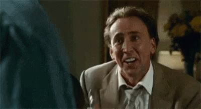 Man in Suit Making Funny Face Talking to Another Man