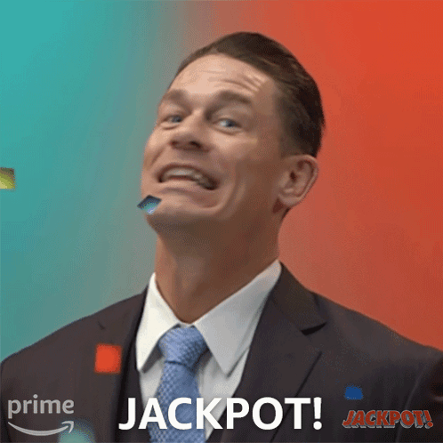 Man In Suit Making Funny Face With Jackpot Behind Him GIF