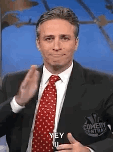Man In Suit Making Funny Face With Thumbs Up GIF