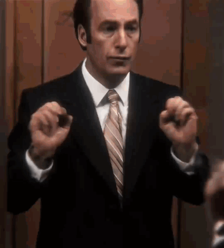 Man in Suit Making Gesture