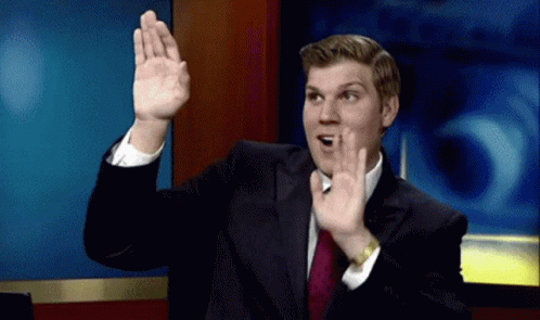 Man in Suit Making Gesture