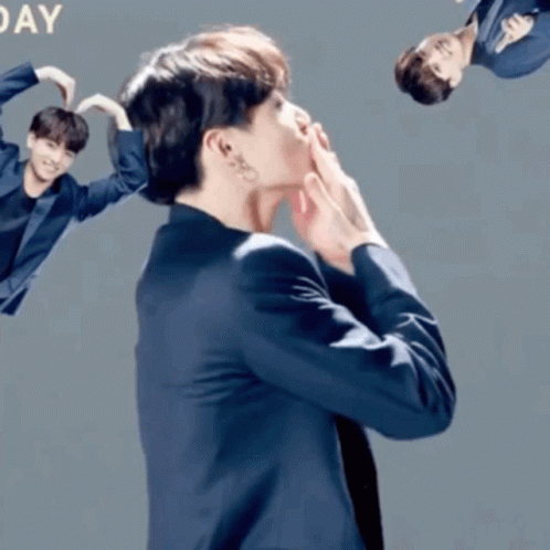 Man in Suit Making Heart With Hands Saying Day